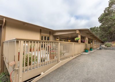 outdoor deck and soft seating and flowers at Monterey Care Center